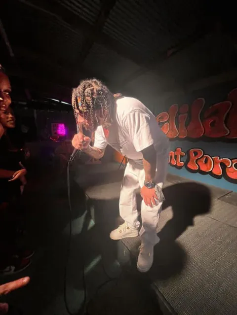 Prezident Cutt performing on a dark stage